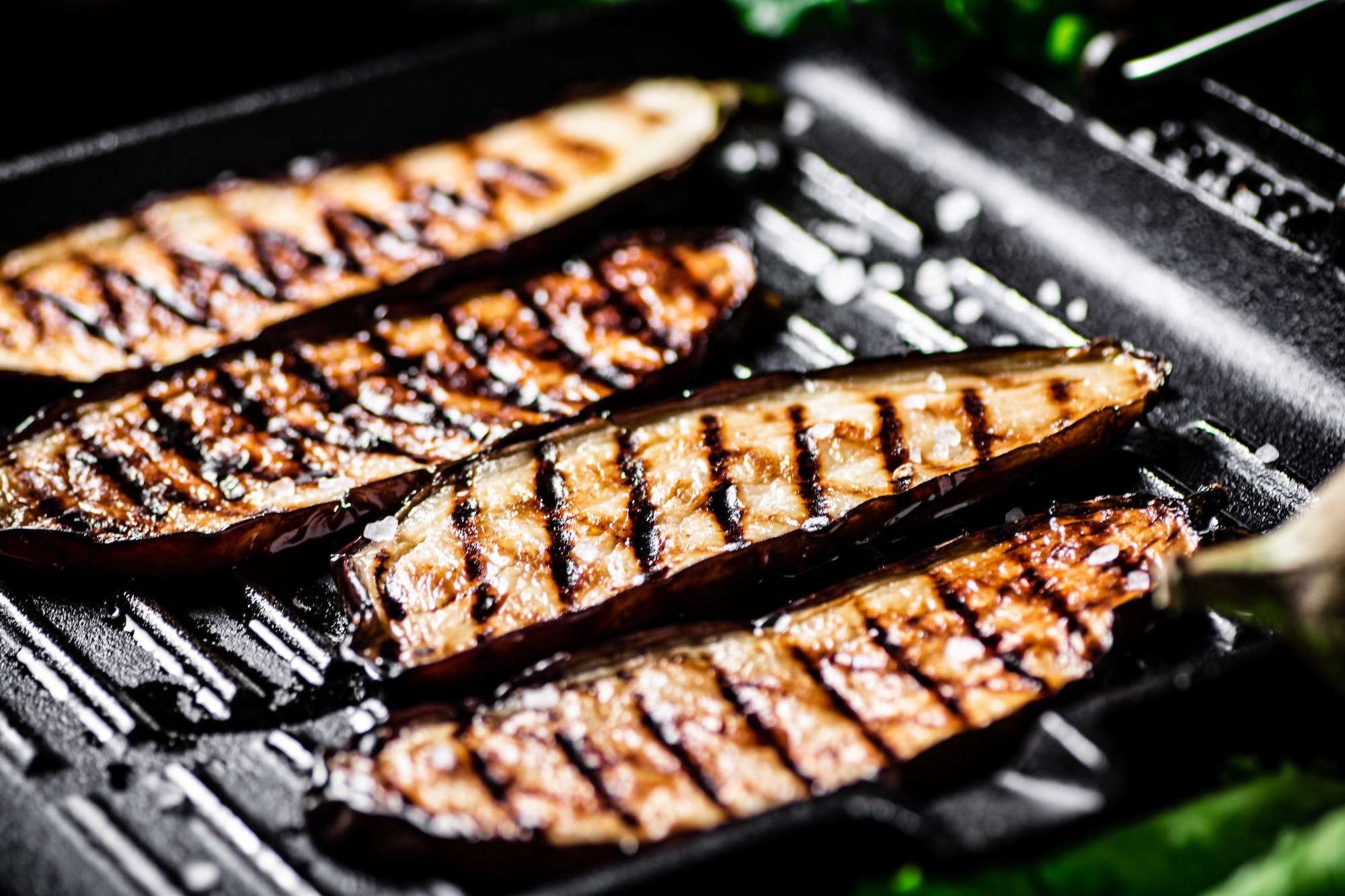 Slices of eggplant in a grill pan.